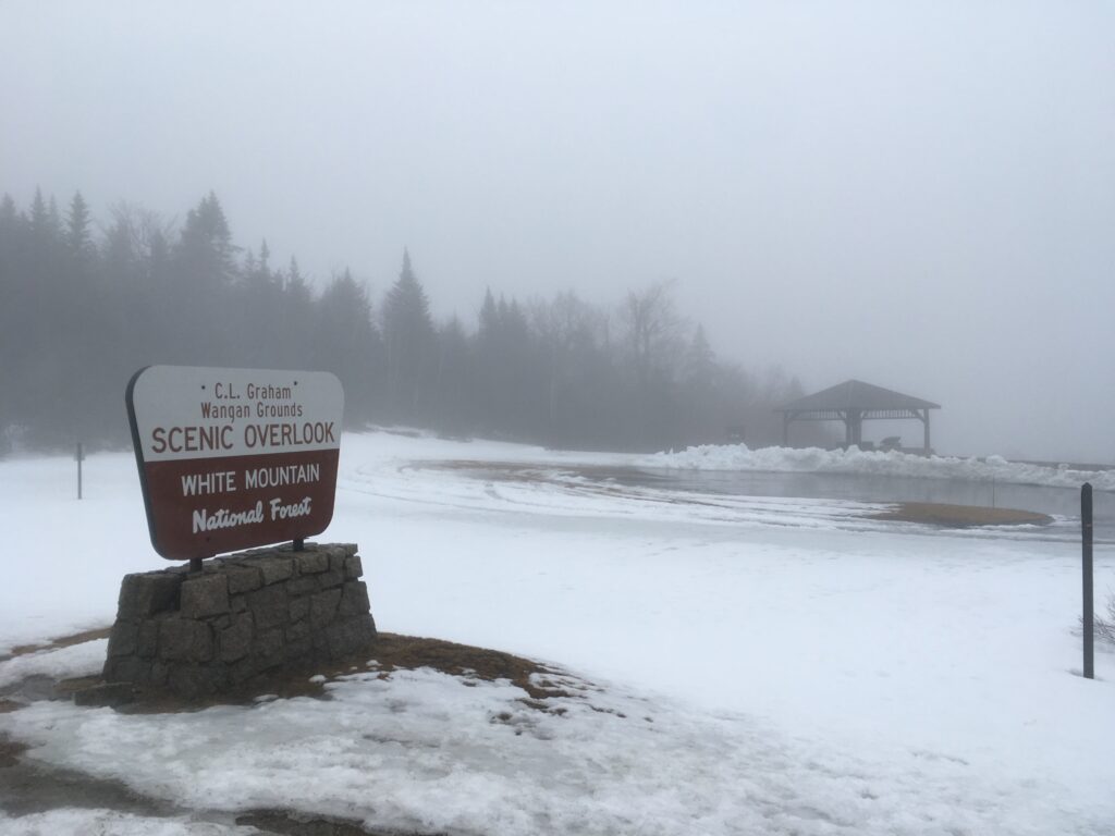 A scenic overlook sign in the White Mountains. It is foggy and raining and hence not so scenic. 
