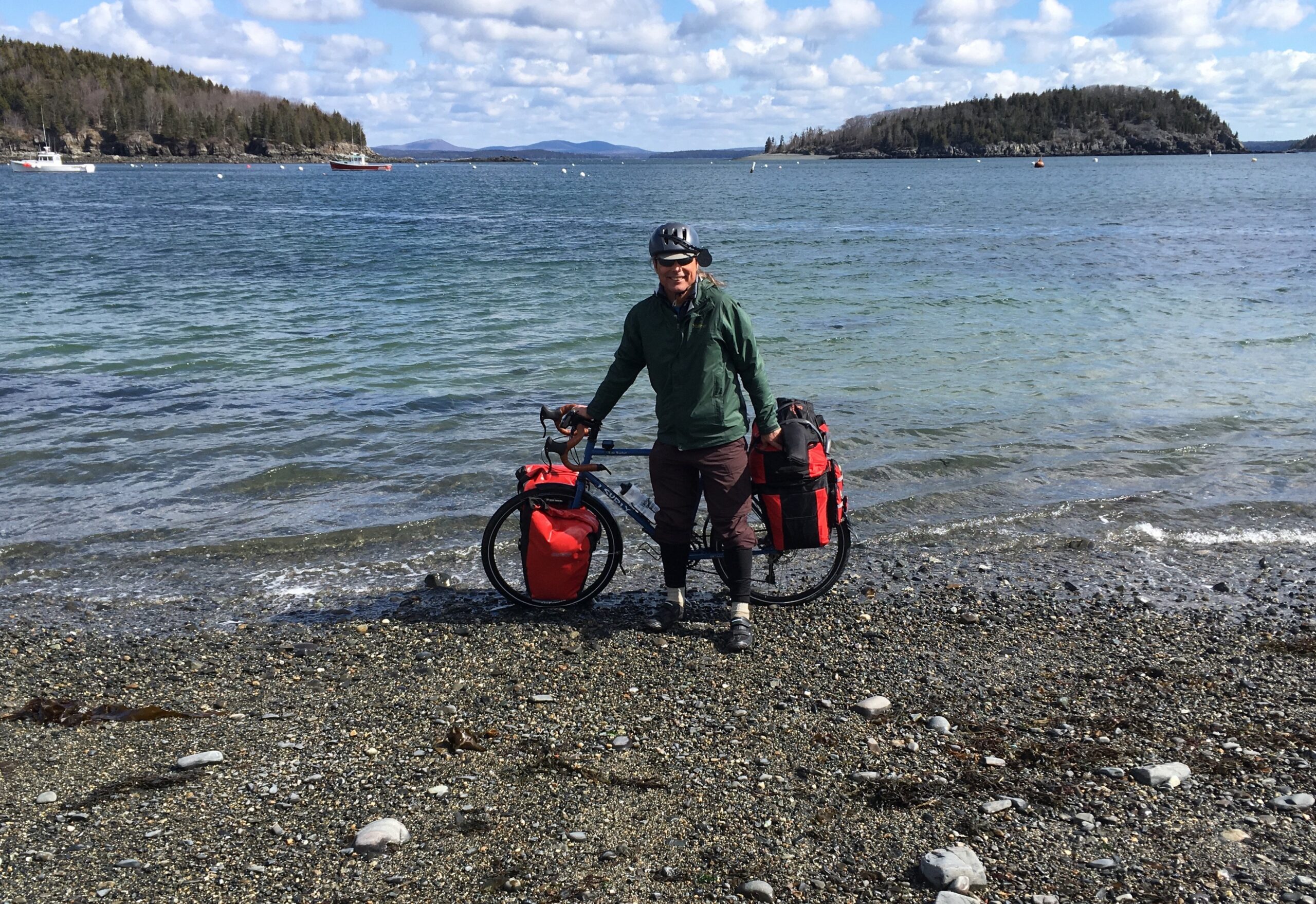 Wes standing with bike at the shore in Bar Harbor